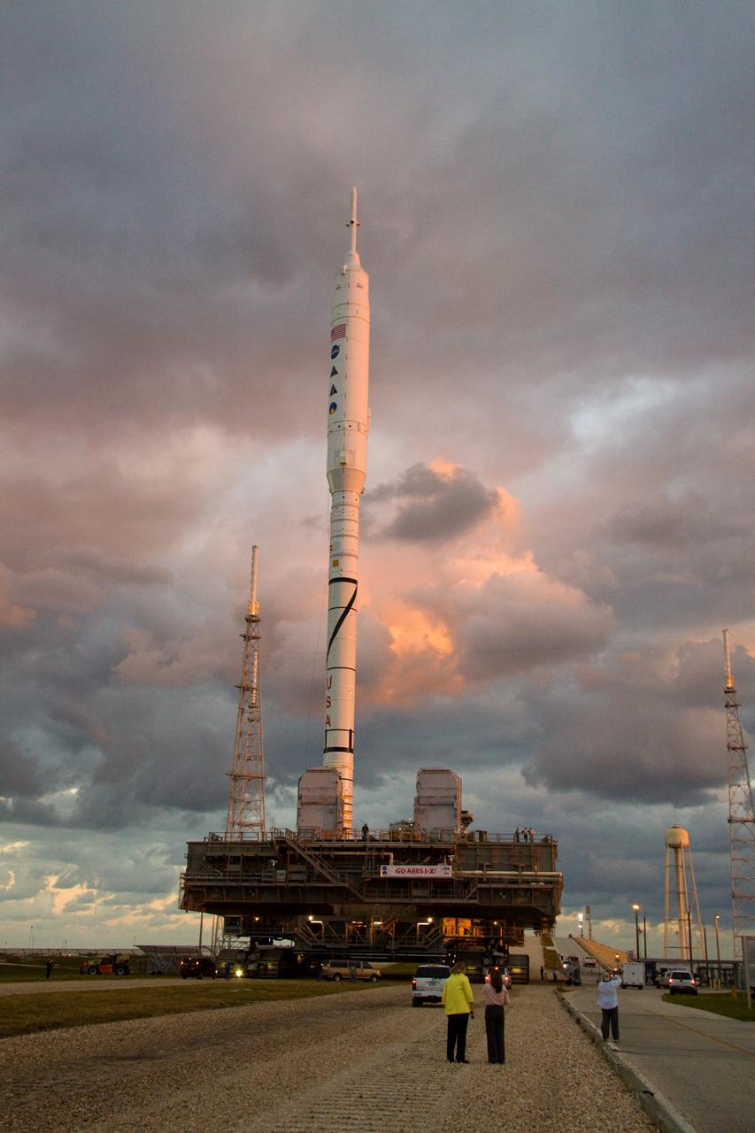 CAPE CANAVERAL, Fla. – As the sun rises over Launch Pad 39B at NASA's Kennedy Space Center in Florida, the 327-foot-tall Ares I-X rocket, secured to a mobile launcher platform, approaches the pad's perimeter fence. The test rocket left the Vehicle Assembly Building at 1:39 a.m. EDT on its 4.2-mile trek to the pad and was "hard down" on the pad’s pedestals at 9:17 a.m. The transfer of the pad from the Space Shuttle Program to the Constellation Program took place May 31. Modifications made to the pad include the removal of shuttle unique subsystems, such as the orbiter access arm and a section of the gaseous oxygen vent arm, along with the installation of three 600-foot lightning towers, access platforms, environmental control systems and a vehicle stabilization system. Part of the Constellation Program, the Ares I-X is the test vehicle for the Ares I. The Ares I-X flight test is targeted for Oct. 27. For information on the Ares I-X vehicle and flight test, visit http://www.nasa.gov/aresIX. Photo credit: NASA/Jack Pfaller