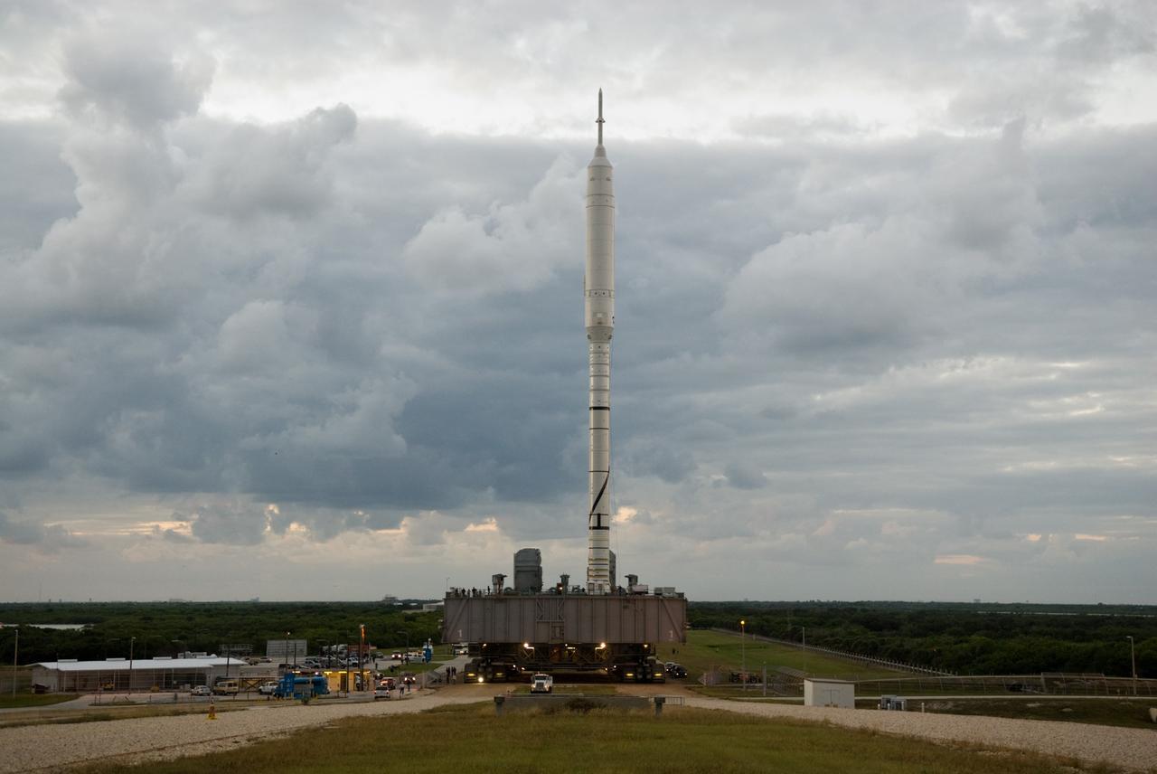 CAPE CANAVERAL, Fla. – As the sun rises over at NASA's Kennedy Space Center in Florida, the 327-foot-tall Ares I-X rocket, secured to a mobile launcher platform, makes steady progress toward the top of Launch Pad 39B.    The test rocket left the Vehicle Assembly Building at 1:39 a.m. EDT on its 4.2-mile trek to the pad and was "hard down" on the pad’s pedestals at 9:17 a.m.  The transfer of the pad from the Space Shuttle Program to the Constellation Program took place May 31. Modifications made to the pad include the removal of shuttle unique subsystems, such as the orbiter access arm and a section of the gaseous oxygen vent arm, along with the installation of three 600-foot lightning towers, access platforms, environmental control systems and a vehicle stabilization system.  Part of the Constellation Program, the Ares I-X is the test vehicle for the Ares I. The Ares I-X flight test is targeted for Oct. 27. For information on the Ares I-X vehicle and flight test, visit http://www.nasa.gov/aresIX.  Photo credit: NASA/Kim Shiflett