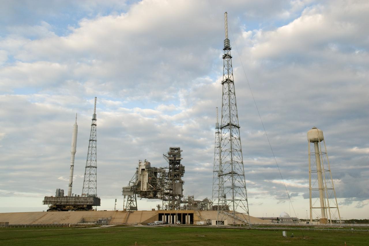 CAPE CANAVERAL, Fla. – The towering 327-foot-tall Ares I-X rocket, secured to a mobile launcher platform, nears its place beside the fixed service structure on Launch Pad 39B at NASA's Kennedy Space Center in Florida.    The test rocket left the Vehicle Assembly Building at 1:39 a.m. EDT on its 4.2-mile trek to the pad and was "hard down" on the pad’s pedestals at 9:17 a.m.  The transfer of the pad from the Space Shuttle Program to the Constellation Program took place May 31. Modifications made to the pad include the removal of shuttle unique subsystems, such as the orbiter access arm and a section of the gaseous oxygen vent arm, along with the installation of three 600-foot lightning towers, access platforms, environmental control systems and a vehicle stabilization system.  Part of the Constellation Program, the Ares I-X is the test vehicle for the Ares I. The Ares I-X flight test is targeted for Oct. 27. For information on the Ares I-X vehicle and flight test, visit http://www.nasa.gov/aresIX.  Photo credit: NASA/Kim Shiflett