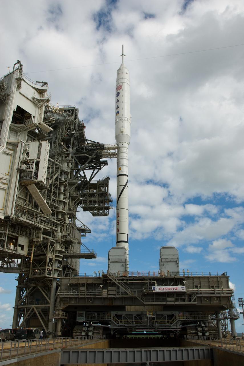 CAPE CANAVERAL, Fla. – The towering 327-foot-tall Ares I-X rocket, newly arrived on Launch Pad 39B at NASA's Kennedy Space Center in Florida, rests securely on its mobile launcher platform following its seven-hour early-morning trek.    The test rocket left the Vehicle Assembly Building at 1:39 a.m. EDT on its 4.2-mile trek to the pad and was "hard down" on the pad’s pedestals at 9:17 a.m.  The transfer of the pad from the Space Shuttle Program to the Constellation Program took place May 31. Modifications made to the pad include the removal of shuttle unique subsystems, such as the orbiter access arm and a section of the gaseous oxygen vent arm, along with the installation of three 600-foot lightning towers, access platforms, environmental control systems and a vehicle stabilization system.  Part of the Constellation Program, the Ares I-X is the test vehicle for the Ares I. The Ares I-X flight test is targeted for Oct. 27. For information on the Ares I-X vehicle and flight test, visit http://www.nasa.gov/aresIX.  Photo credit: NASA/Kim Shiflett