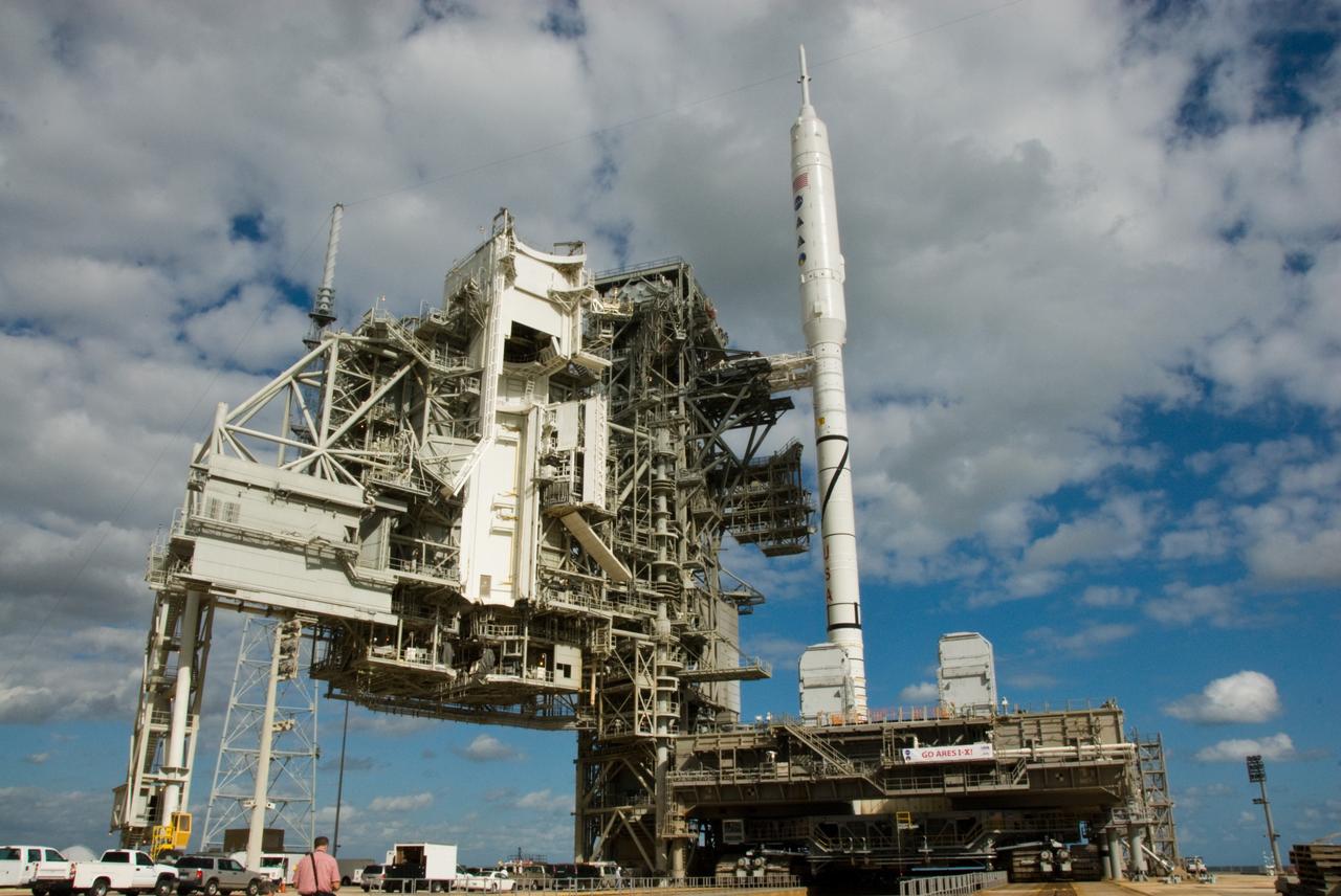 CAPE CANAVERAL, Fla. – The towering 327-foot-tall Ares I-X rocket, newly arrived on Launch Pad 39B at NASA's Kennedy Space Center in Florida, confidently greats the day following its seven-hour early-morning trek.    The test rocket left the Vehicle Assembly Building at 1:39 a.m. EDT on its 4.2-mile trek to the pad and was "hard down" on the pad’s pedestals at 9:17 a.m.  The transfer of the pad from the Space Shuttle Program to the Constellation Program took place May 31. Modifications made to the pad include the removal of shuttle unique subsystems, such as the orbiter access arm and a section of the gaseous oxygen vent arm, along with the installation of three 600-foot lightning towers, access platforms, environmental control systems and a vehicle stabilization system.  Part of the Constellation Program, the Ares I-X is the test vehicle for the Ares I. The Ares I-X flight test is targeted for Oct. 27. For information on the Ares I-X vehicle and flight test, visit http://www.nasa.gov/aresIX.  Photo credit: NASA/Kim Shiflett