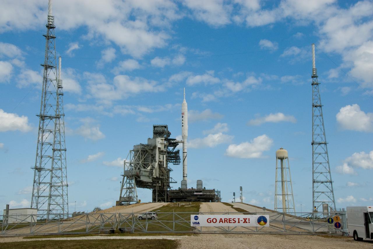 CAPE CANAVERAL, Fla. – The perimeter fence on Launch Pad 39B at NASA's Kennedy Space Center in Florida, is closed following the arrival of the towering 327-foot-tall Ares I-X rocket following its seven-hour early-morning trek.    The test rocket left the Vehicle Assembly Building at 1:39 a.m. EDT on its 4.2-mile trek to the pad and was "hard down" on the pad’s pedestals at 9:17 a.m.  The transfer of the pad from the Space Shuttle Program to the Constellation Program took place May 31. Modifications made to the pad include the removal of shuttle unique subsystems, such as the orbiter access arm and a section of the gaseous oxygen vent arm, along with the installation of three 600-foot lightning towers, access platforms, environmental control systems and a vehicle stabilization system.  Part of the Constellation Program, the Ares I-X is the test vehicle for the Ares I. The Ares I-X flight test is targeted for Oct. 27. For information on the Ares I-X vehicle and flight test, visit http://www.nasa.gov/aresIX.  Photo credit: NASA/Kim Shiflett