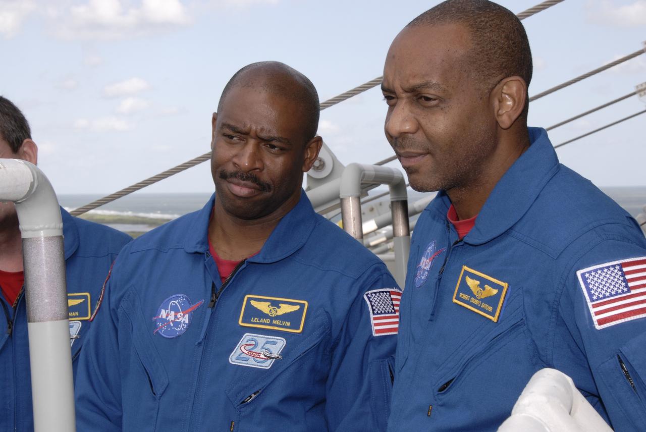 CAPE CANAVERAL, Fla. - Members of space shuttle Atlantis' STS-129 crew are instructed on the operation of the emergency escape slidewire baskets at Launch Pad 39A at NASA's Kennedy Space Center in Florida. From left are Mission Specialists Leland Melvin and Robert L. Satcher Jr.    The crew members of space shuttle Atlantis' STS-129 mission are at Kennedy for training related to their launch dress rehearsal, the Terminal Countdown Demonstration Test.  Launch of Atlantis on its STS-129 mission to the International Space Station is targeted for Nov. 16. For information on the STS-129 mission objectives and crew, visit http://www.nasa.gov/mission_pages/shuttle/shuttlemissions/sts129/index.html.  Photo credit: NASA/Kim Shiflett