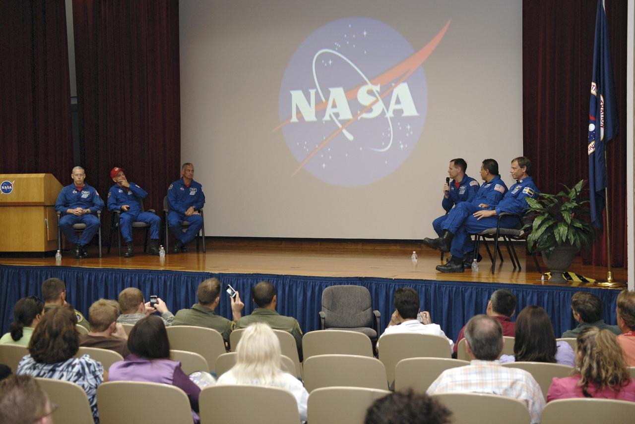 CAPE CANAVERAL, Fla. – In the Training Auditorium at NASA's Kennedy Space Center in Florida, the members of the STS-128 space shuttle crew make a presentation to Kennedy employees about their experiences on the mission. Seated from left are Mission Specialist Patrick Forrester; Commander Rick Sturckow; Mission Specialist John "Danny" Olivas; Pilot Kevin Ford; and Mission Specialists Jose Hernandez and Christer Fuglesang.    More than 7 tons of supplies, science racks and equipment, as well as additional environmental hardware to sustain six crew members on the International Space Station were delivered to the International Space Station on the STS-128 mission. The equipment included a freezer to store research samples, a new sleeping compartment and the COLBERT treadmill.  The mission was the 128th in the Space Shuttle Program, the 37th flight of Discovery and the 30th station assembly flight. Launch was Aug. 28, 2009.  Photo credit: NASA/Kim Shiflett