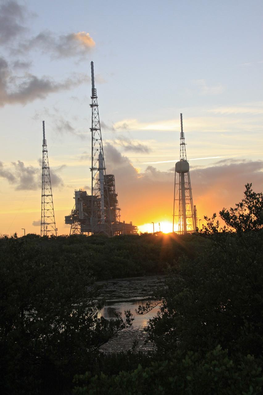 CAPE CANAVERAL, Fla. – As the sun falls behind Launch Pad 39B at NASA's Kennedy Space Center in Florida, the rotating service structure, or RSS, has been retracted from the 327-foot-tall Ares I-X rocket to allow a full test of the rocket to be conducted.    The transfer of the pad from the Space Shuttle Program to the Constellation Program took place May 31. Modifications made to the pad include the removal of shuttle unique subsystems, such as the orbiter access arm and a section of the gaseous oxygen vent arm, along with the installation of three 600-foot lightning towers, access platforms, environmental control systems and a vehicle stabilization system.  Part of the Constellation Program, the Ares I-X is the test vehicle for the Ares I. The Ares I-X flight test is targeted for Oct. 27. For information on the Ares I-X vehicle and flight test, visit http://www.nasa.gov/aresIX. Photo credit: NASA/Jack Pfaller
