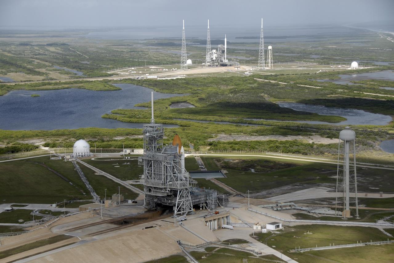 CAPE CANAVERAL, Fla. – At NASA's Kennedy Space Center in Florida, space shuttle Atlantis awaits liftoff from Launch Pad 39A, in the foreground, while processing of the Ares I-X rocket draws to a close on Launch Pad 39B, in the background.    The Ares I-X flight test is set for Oct. 27; space shuttle Atlantis' STS-129 launch to the International Space Station is targeted for Nov. 16.  For information on the Ares I-X vehicle and flight test, visit http://www.nasa.gov/aresIX.  For information on the STS-129 mission and crew, visit http://www.nasa.gov/shuttle.  Photo credit: NASA/Kim Shiflett