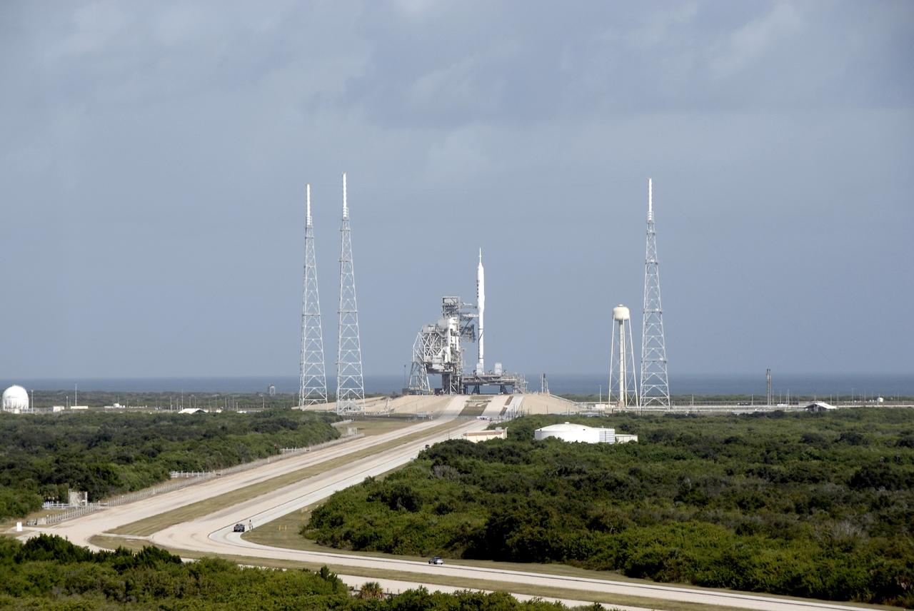 CAPE CANAVERAL, Fla. – The 327-foot-tall Ares I-X rocket is not the tallest structure on Launch Pad 39B at NASA's Kennedy Space Center in Florida. Situated around the pad are three 100-foot fiberglass lightning masts mounted atop 500-foot towers.  This is the first time since the Apollo Program's Saturn rockets were retired that a vehicle other than the space shuttle has resided on the pad. The transfer of the pad from the Space Shuttle Program to the Constellation Program took place May 31. Pad modifications to support the Ares I-X include the removal of shuttle unique subsystems, such as the orbiter access arm and a section of the gaseous oxygen vent arm, and the installation of three 600-foot lightning towers, access platforms, environmental control systems and a vehicle stabilization system.  Part of the Constellation Program, the Ares I-X is the test vehicle for the Ares I.  The Ares I-X flight test is set for Oct. 27.  For information on the Ares I-X vehicle and flight test, visit http://www.nasa.gov/aresIX.      Photo credit: NASA/Kim Shiflett