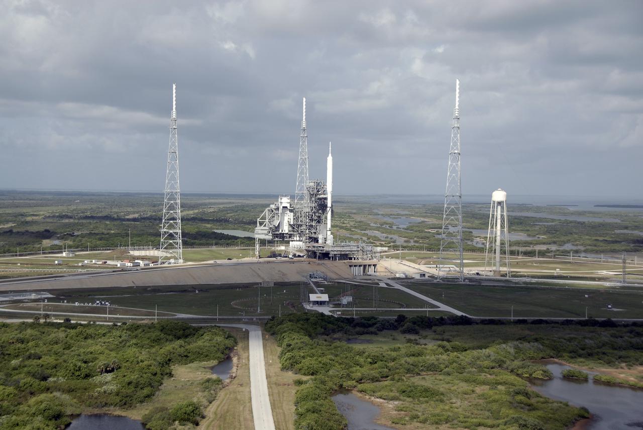 CAPE CANAVERAL, Fla. – The 327-foot-tall Ares I-X rocket is not the tallest structure on Launch Pad 39B at NASA's Kennedy Space Center in Florida. Situated around the pad are three 100-foot fiberglass lightning masts mounted atop 500-foot towers.  This is the first time since the Apollo Program's Saturn rockets were retired that a vehicle other than the space shuttle has been processed on the pad. The transfer of the pad from the Space Shuttle Program to the Constellation Program took place May 31. Pad modifications to support the Ares I-X include the removal of shuttle unique subsystems, such as the orbiter access arm and a section of the gaseous oxygen vent arm, and the installation of three 600-foot lightning towers, access platforms, environmental control systems and a vehicle stabilization system.  Part of the Constellation Program, the Ares I-X is the test vehicle for the Ares I.  The Ares I-X flight test is set for Oct. 27.  For information on the Ares I-X vehicle and flight test, visit http://www.nasa.gov/aresIX.    Photo credit: NASA/Kim Shiflett