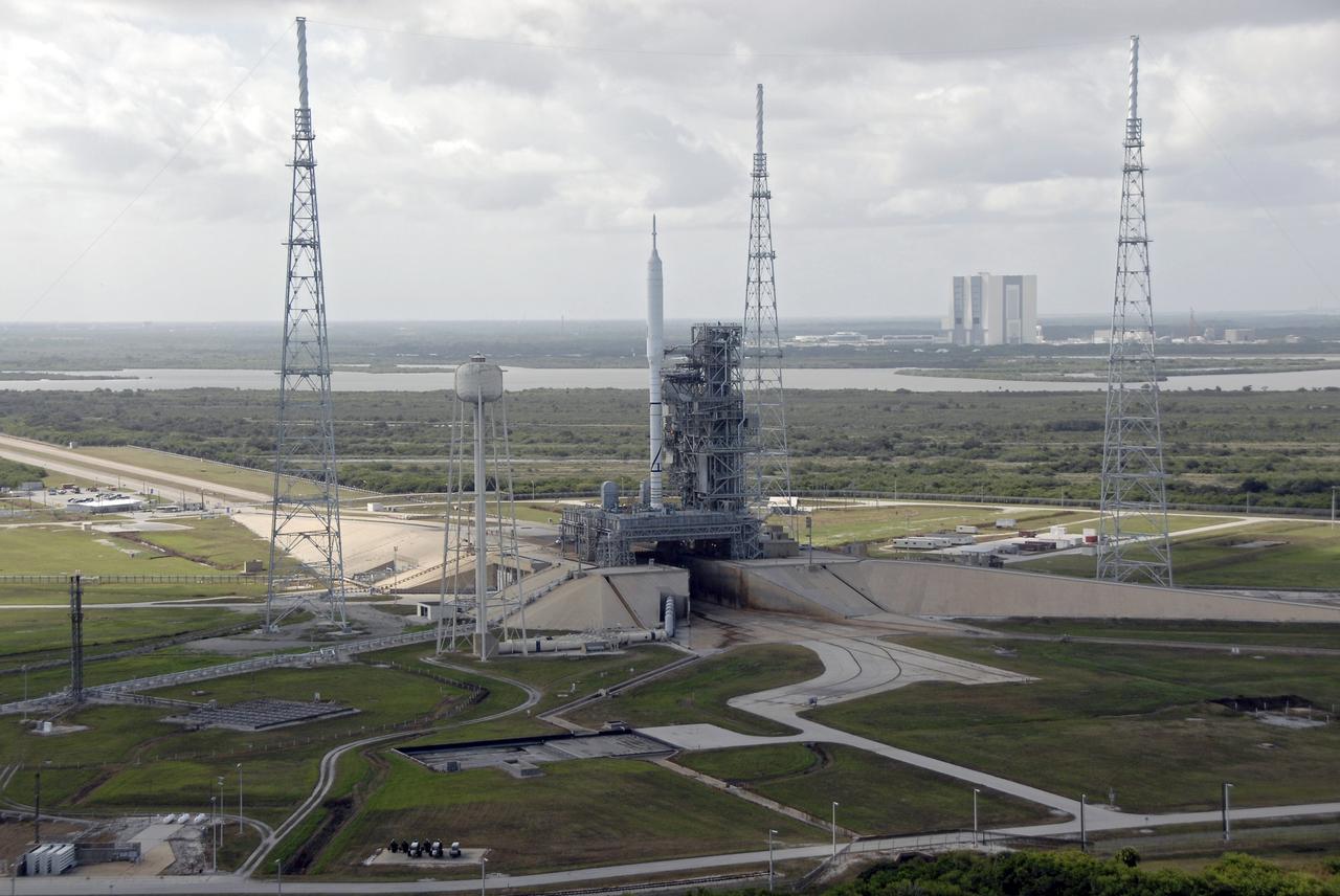 CAPE CANAVERAL, Fla. – At NASA's Kennedy Space Center in Florida, the 327-foot-tall Ares I-X rocket undergoes final processing on Launch Pad 39B for its upcoming flight test. The 525-foot Vehicle Assembly Building, or VAB, where the rocket was assembled is in the background. The rocket's 4.2-mile move from the VAB to the pad, known as rollout, took place Oct. 20.  Pad modifications to support the Ares I-X include the removal of shuttle unique subsystems, such as the orbiter access arm and a section of the gaseous oxygen vent arm, and the installation of three 600-foot lightning towers, access platforms, environmental control systems and a vehicle stabilization system.  Part of the Constellation Program, the Ares I-X is the test vehicle for the Ares I.  The Ares I-X flight test is set for Oct. 27.  For information on the Ares I-X vehicle and flight test, visit http://www.nasa.gov/aresIX.    Photo credit: NASA/Kim Shiflett