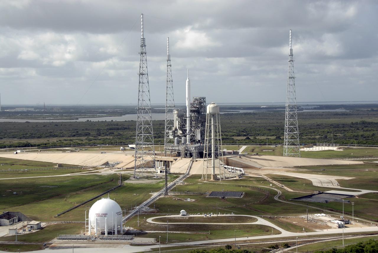 CAPE CANAVERAL, Fla. – At NASA's Kennedy Space Center in Florida, the 327-foot-tall Ares I-X rocket awaits liftoff on Launch Pad 39B on its upcoming flight test. In the distance are the pads and processing facilities on Cape Canaveral Air Force Station. This is the first time since the Apollo Program's Saturn rockets were retired that a vehicle other than the space shuttle has occupied the pad. Modifications to the pad to support the Ares I-X included the removal of shuttle unique subsystems, such as the orbiter access arm and a section of the gaseous oxygen vent arm, and the installation of three 600-foot lightning towers, access platforms, environmental control systems and a vehicle stabilization system. Part of the Constellation Program, the Ares I-X is the test vehicle for the Ares I. The Ares I-X flight test is set for Oct. 27. For information on the Ares I-X vehicle and flight test, visit http://www.nasa.gov/aresIX. Photo credit: NASA/Kim Shiflett