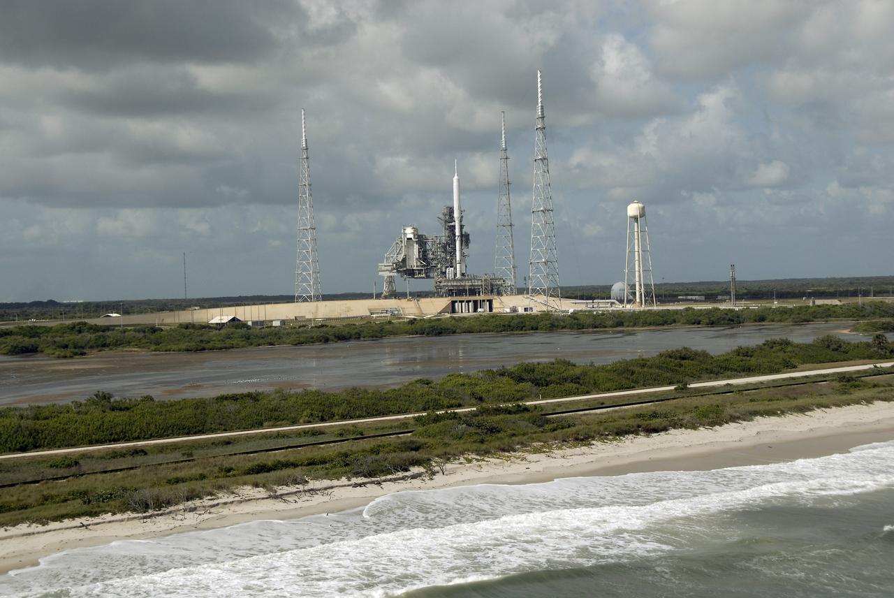 CAPE CANAVERAL, Fla. - Waves lap the shore of the Atlantic Ocean near Launch Pad 39B at NASA's Kennedy Space Center in Florida.  On the pad, the Ares I-X rocket awaits liftoff on its upcoming flight test.  This is the first time since the Apollo Program's Saturn rockets were retired that a vehicle other than the space shuttle has occupied the pad.  Modifications to the pad to support the Ares I-X included the removal of shuttle unique subsystems, such as the orbiter access arm and a section of the gaseous oxygen vent arm, and the installation of three 600-foot lightning towers, access platforms, environmental control systems and a vehicle stabilization system.  Part of the Constellation Program, the Ares I-X is the test vehicle for the Ares I.  The Ares I-X flight test is set for Oct. 27.  For information on the Ares I-X vehicle and flight test, visit http://www.nasa.gov/aresIX. Photo credit: NASA/Kim Shiflett