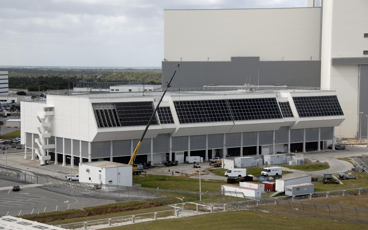 CAPE CANAVERAL, Fla. – This aerial view of the Launch Control Center at NASA's Kennedy Space Center in Florida shows the installation of new windows nearing completion. New, hurricane-rated window systems for the four Firing Rooms and the vestibule areas between Firing Rooms 1 and 2 and Firing Rooms 3 and 4 are being installed. In order to avoid operational impacts the new windows are being installed on the outside of the existing windows, enclosing the space formerly occupied by the louvers. The old windows will remain in place until the new windows are completely installed and leak tested. This approach will continue to keep the firing rooms from being exposed to the elements.  Photo credit: NASA/Kim Shiflett