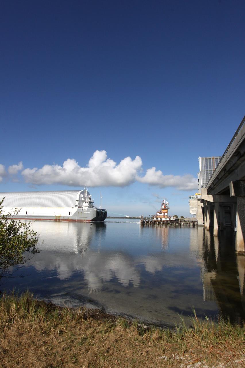 CAPE CANAVERAL, Fla. – A bright sun and blue sky herald the passage of the Pegasus barge, carrying external tank 134, through Port Canaveral. The tugboat will move the barge through the Banana River toward the turn basin near the Vehicle Assembly Building, or VAB, at NASA's Kennedy Space Center in Florida. Pegasus arrived in Florida after an ocean voyage towed by a solid rocket booster retrieval ship from NASA's Michoud Assembly Facility near New Orleans. After Pegasus docks in the turn basin, the fuel tank will be offloaded and transported into the VAB. ET-134 will be used to launch space shuttle Endeavour on the STS-130 mission to the International Space Station. Launch is targeted for Feb. 4, 2010. For information on the components of the space shuttle and the STS-130 mission, visit http://www.nasa.gov/shuttle. Photo credit: NASA/Jack Pfaller