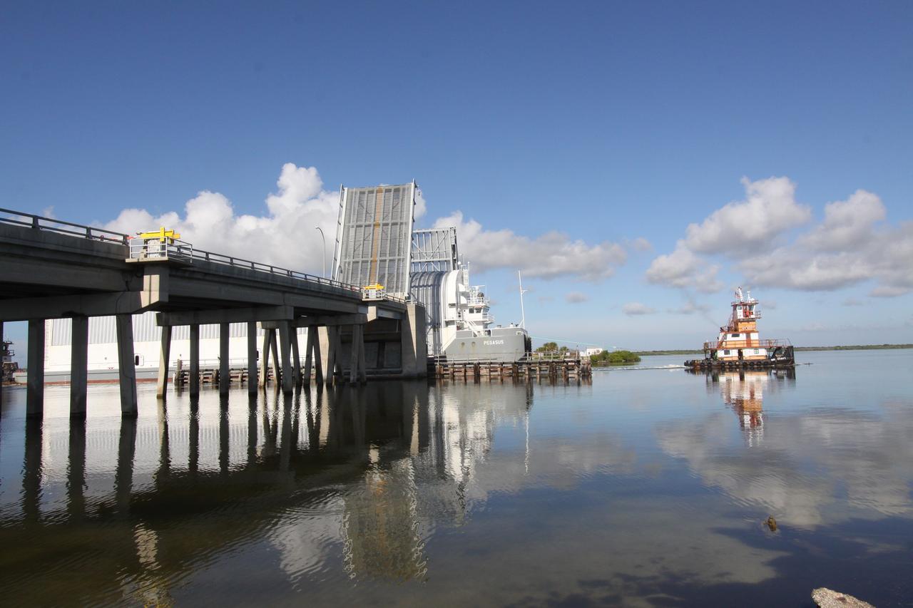 CAPE CANAVERAL, Fla. – The Pegasus barge, carrying external tank 134, passes through a bridge into the river near Port Canaveral. The tugboat will move the barge through the Banana River toward the turn basin near the Vehicle Assembly Building, or VAB, at NASA's Kennedy Space Center in Florida. Pegasus arrived in Florida after an ocean voyage towed by a solid rocket booster retrieval ship from NASA's Michoud Assembly Facility near New Orleans. After Pegasus docks in the turn basin, the fuel tank will be offloaded and transported into the VAB. ET-134 will be used to launch space shuttle Endeavour on the STS-130 mission to the International Space Station. Launch is targeted for Feb. 4, 2010. For information on the components of the space shuttle and the STS-130 mission, visit http://www.nasa.gov/shuttle. Photo credit: NASA/Jack Pfaller