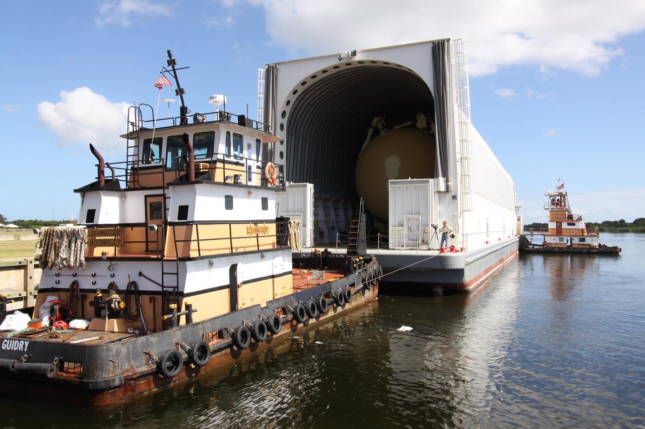 CAPE CANAVERAL, Fla. – Tugboats safely deliver the Pegasus barge, carrying external tank 134, to the dock in the turn basin near the Vehicle Assembly Building, or VAB, at NASA's Kennedy Space Center in Florida. Pegasus arrived in Florida after an ocean voyage towed by a solid rocket booster retrieval ship from NASA's Michoud Assembly Facility near New Orleans. After Pegasus docks in the turn basin, the fuel tank will be offloaded and transported into the VAB. ET-134 will be used to launch space shuttle Endeavour on the STS-130 mission to the International Space Station. Launch is targeted for Feb. 4, 2010. For information on the components of the space shuttle and the STS-130 mission, visit http://www.nasa.gov/shuttle. Photo credit: NASA/Jack Pfaller