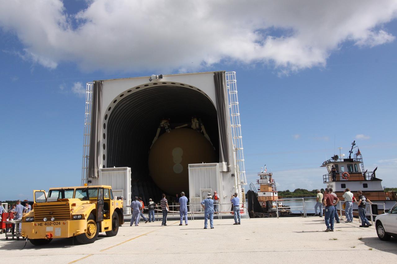 CAPE CANAVERAL, Fla. – Workers prepare to offload external tank 134 from the Pegasus barge docked in the turn basin near the Vehicle Assembly Building, or VAB, at NASA's Kennedy Space Center in Florida. Pegasus arrived in Florida after an ocean voyage towed by a solid rocket booster retrieval ship from NASA's Michoud Assembly Facility near New Orleans. After Pegasus docks in the turn basin, the fuel tank will be offloaded and transported into the VAB. ET-134 will be used to launch space shuttle Endeavour on the STS-130 mission to the International Space Station. Launch is targeted for Feb. 4, 2010. For information on the components of the space shuttle and the STS-130 mission, visit http://www.nasa.gov/shuttle. Photo credit: NASA/Jack Pfaller