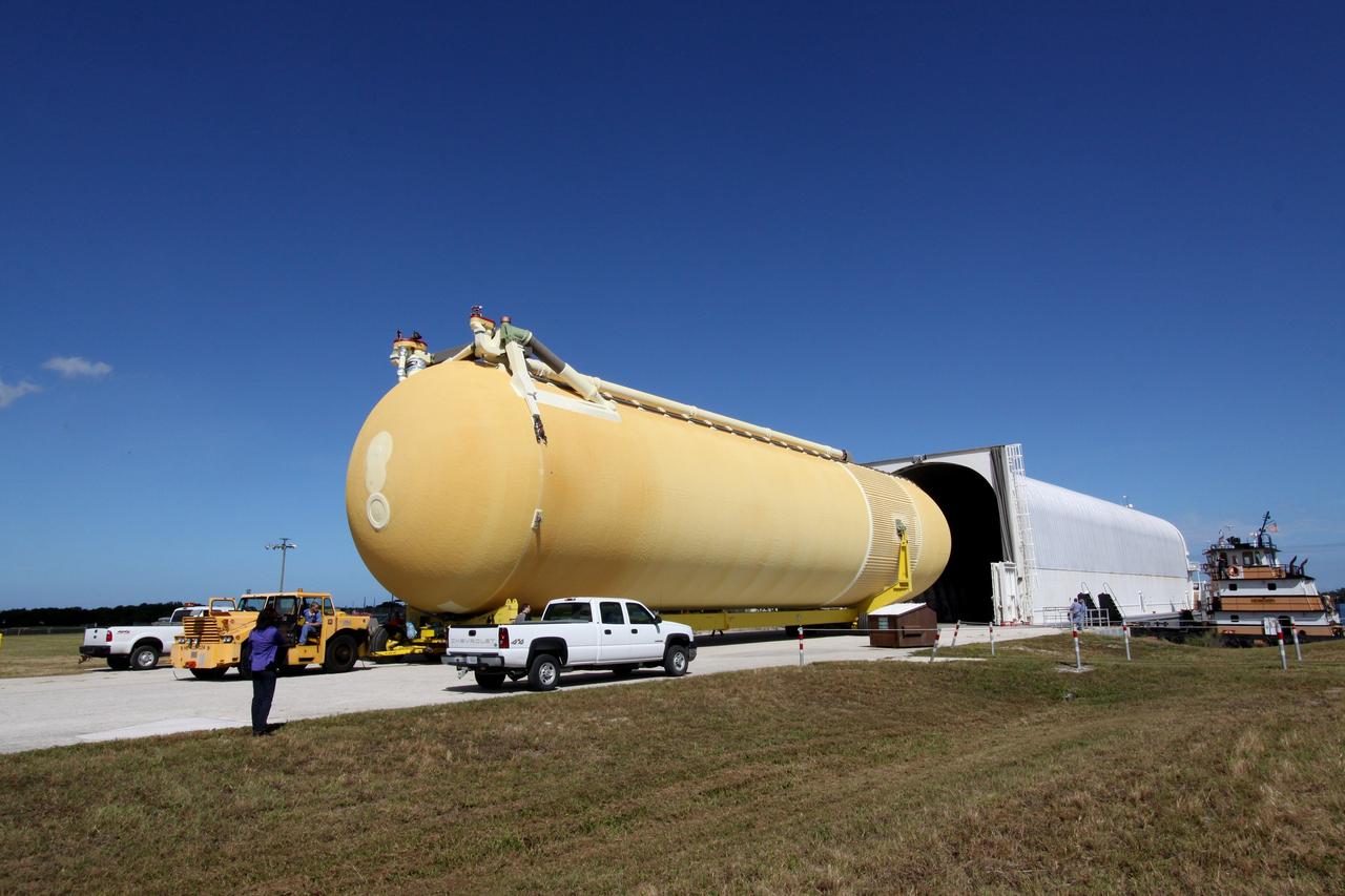 CAPE CANAVERAL, Fla. – External tank 134 emerges from the Pegasus barge docked in the turn basin near the Vehicle Assembly Building, or VAB, at NASA's Kennedy Space Center in Florida. Pegasus arrived in Florida after an ocean voyage towed by a solid rocket booster retrieval ship from NASA's Michoud Assembly Facility near New Orleans. The fuel tank next will be transported into the VAB where it will be stored until needed. ET-134 will be used to launch space shuttle Endeavour on the STS-130 mission to the International Space Station. Launch is targeted for Feb. 4, 2010. For information on the components of the space shuttle and the STS-130 mission, visit http://www.nasa.gov/shuttle. Photo credit: NASA/Jack Pfaller