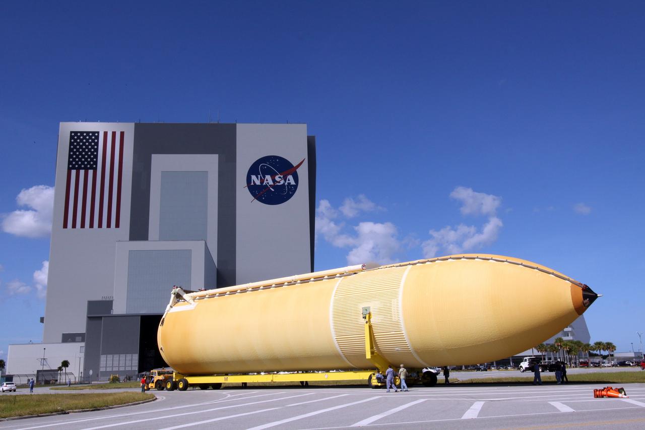 CAPE CANAVERAL, Fla. – External tank 134 is towed toward the looming 525-foot-tall Vehicle Assembly Building, or VAB, at NASA's Kennedy Space Center in Florida. The Pegasus barge, carrying the fuel tank, arrived in Florida after an ocean voyage towed by a solid rocket booster retrieval ship from NASA's Michoud Assembly Facility near New Orleans. Next, the tank will be transported into the VAB where it will be stored until needed. ET-134 will be used to launch space shuttle Endeavour on the STS-130 mission to the International Space Station. Launch is targeted for Feb. 4, 2010. For information on the components of the space shuttle and the STS-130 mission, visit http://www.nasa.gov/shuttle. Photo credit: NASA/Jack Pfaller