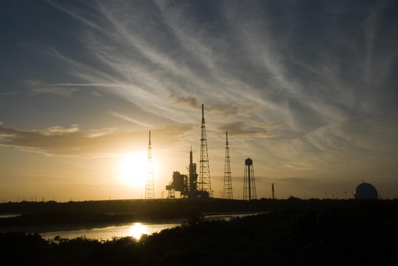 CAPE CANAVERAL, Fla. - As the sun sets behind Launch Complex 39B at NASA's Kennedy Space Center in Florida, the Ares I-X rocket awaits the approaching liftoff of its flight test. This is the first time since the Apollo Program's Saturn rockets were retired that a vehicle other than the space shuttle has occupied the pad. Part of the Constellation Program, the Ares I-X is the test vehicle for the Ares I. The Ares I-X flight test is set for Oct. 27. For information on the Ares I-X vehicle and flight test, visit http://www.nasa.gov/aresIX. Photo credit: NASA/Kim Shiflett