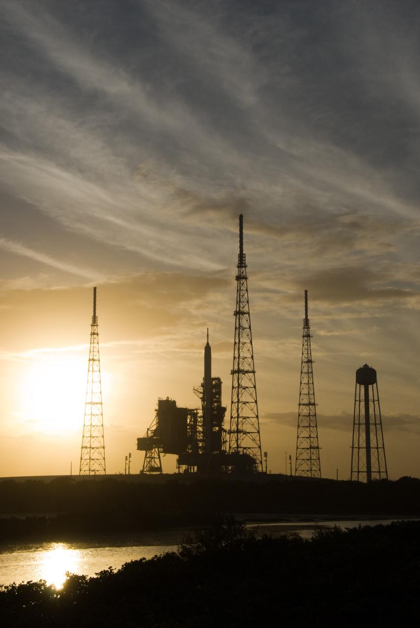 CAPE CANAVERAL, Fla. - As the sun sets behind Launch Complex 39B at NASA's Kennedy Space Center in Florida, the Ares I-X rocket awaits the approaching liftoff of its flight test.    This is the first time since the Apollo Program's Saturn rockets were retired that a vehicle other than the space shuttle has occupied the pad.   Part of the Constellation Program, the Ares I-X is the test vehicle for the Ares I.  The Ares I-X flight test is set for Oct. 27.  For information on the Ares I-X vehicle and flight test, visit http://www.nasa.gov/aresIX. Photo credit: NASA/Kim Shiflett