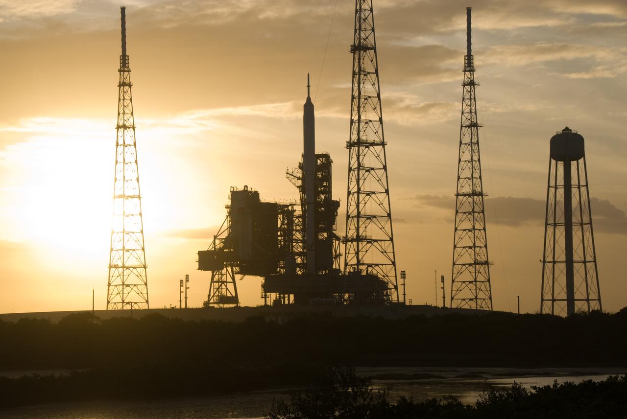 CAPE CANAVERAL, Fla. - As the sun sets behind Launch Complex 39B at NASA's Kennedy Space Center in Florida, the Ares I-X rocket awaits the approaching liftoff of its flight test. This is the first time since the Apollo Program's Saturn rockets were retired that a vehicle other than the space shuttle has occupied the pad. Part of the Constellation Program, the Ares I-X is the test vehicle for the Ares I. The Ares I-X flight test is set for Oct. 27. For information on the Ares I-X vehicle and flight test, visit http://www.nasa.gov/aresIX. Photo credit: NASA/Kim Shiflett