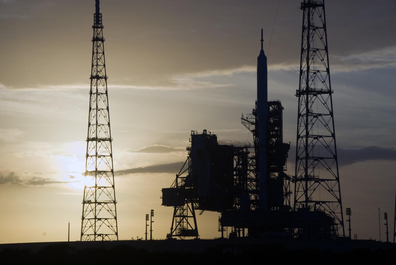 CAPE CANAVERAL, Fla. - As the sun sets behind Launch Complex 39B at NASA's Kennedy Space Center in Florida, the Ares I-X rocket awaits the approaching liftoff of its flight test. This is the first time since the Apollo Program's Saturn rockets were retired that a vehicle other than the space shuttle has occupied the pad. Part of the Constellation Program, the Ares I-X is the test vehicle for the Ares I. The Ares I-X flight test is set for Oct. 27. For information on the Ares I-X vehicle and flight test, visit http://www.nasa.gov/aresIX. Photo credit: NASA/Kim Shiflett