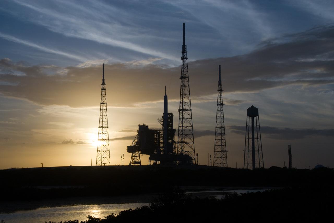 CAPE CANAVERAL, Fla. - As the sun sets behind Launch Complex 39B at NASA's Kennedy Space Center in Florida, the Ares I-X rocket awaits the approaching liftoff of its flight test.    This is the first time since the Apollo Program's Saturn rockets were retired that a vehicle other than the space shuttle has occupied the pad.   Part of the Constellation Program, the Ares I-X is the test vehicle for the Ares I.  The Ares I-X flight test is set for Oct. 27.  For information on the Ares I-X vehicle and flight test, visit http://www.nasa.gov/aresIX. Photo credit: NASA/Kim Shiflett
