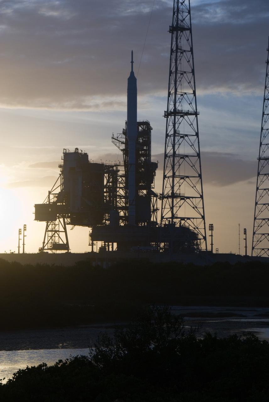 CAPE CANAVERAL, Fla. - Sunset at Launch Pad 39B at NASA's Kennedy Space Center in Florida finds the Ares I-X rocket awaiting the approaching liftoff of its flight test. This is the first time since the Apollo Program's Saturn rockets were retired that a vehicle other than the space shuttle has occupied the pad. Part of the Constellation Program, the Ares I-X is the test vehicle for the Ares I. The Ares I-X flight test is set for Oct. 27. For information on the Ares I-X vehicle and flight test, visit http://www.nasa.gov/aresIX. Photo credit: NASA/Kim Shiflett