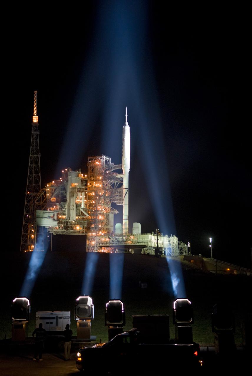 CAPE CANAVERAL, Fla. - As nightfall comes to Launch Complex 39B at NASA's Kennedy Space Center in Florida, xenon lights illuminate the pad and the Ares I-X rocket awaiting the approaching liftoff of its flight test.    This is the first time since the Apollo Program's Saturn rockets were retired that a vehicle other than the space shuttle has occupied the pad.   Part of the Constellation Program, the Ares I-X is the test vehicle for the Ares I.  The Ares I-X flight test is set for Oct. 27.  For information on the Ares I-X vehicle and flight test, visit http://www.nasa.gov/aresIX. Photo credit: NASA/Kim Shiflett