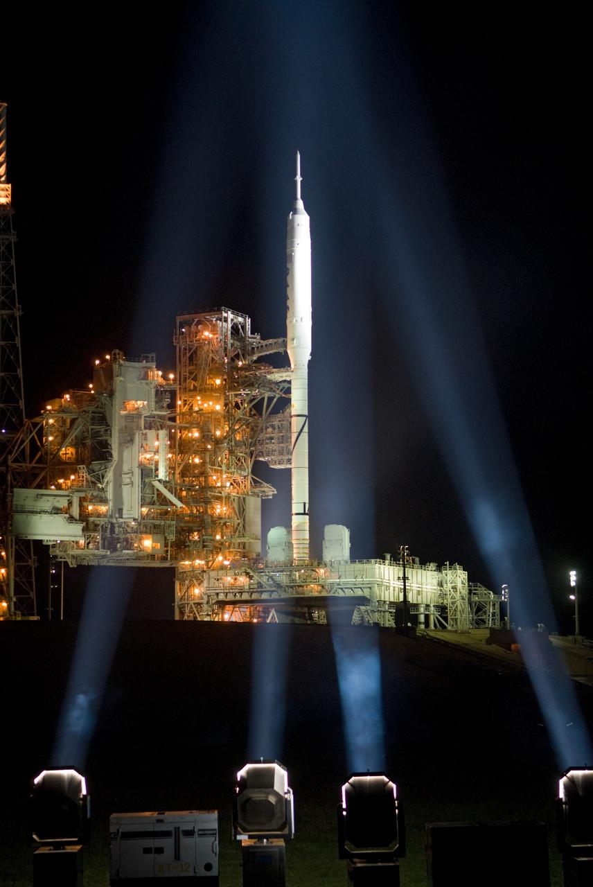 CAPE CANAVERAL, Fla. - As nightfall comes to Launch Complex 39B at NASA's Kennedy Space Center in Florida, xenon lights illuminate the pad and the Ares I-X rocket awaiting the approaching liftoff of its flight test.    This is the first time since the Apollo Program's Saturn rockets were retired that a vehicle other than the space shuttle has occupied the pad.   Part of the Constellation Program, the Ares I-X is the test vehicle for the Ares I.  The Ares I-X flight test is set for Oct. 27.  For information on the Ares I-X vehicle and flight test, visit http://www.nasa.gov/aresIX. Photo credit: NASA/Kim Shiflett