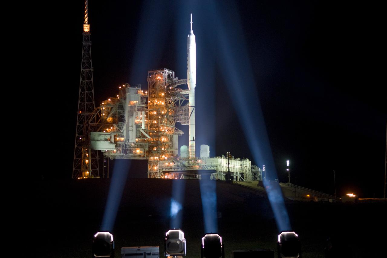 CAPE CANAVERAL, Fla. - As nightfall comes to Launch Complex 39B at NASA's Kennedy Space Center in Florida, xenon lights illuminate the pad and the Ares I-X rocket awaiting the approaching liftoff of its flight test.    This is the first time since the Apollo Program's Saturn rockets were retired that a vehicle other than the space shuttle has occupied the pad.   Part of the Constellation Program, the Ares I-X is the test vehicle for the Ares I.  The Ares I-X flight test is set for Oct. 27.  For information on the Ares I-X vehicle and flight test, visit http://www.nasa.gov/aresIX. Photo credit: NASA/Kim Shiflett