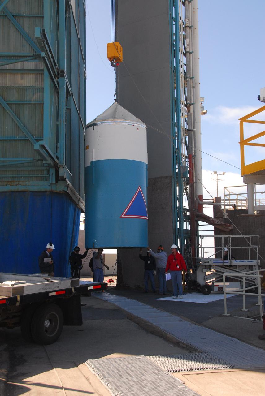VANDENBERG AIR FORCE BASE, Calif. - At Space Launch Complex 2 at Vandenberg Air Force Base in California, the interstage of the United Launch Alliance Delta II rocket for launch of NASA's Wide-field Infrared Survey Explorer, or WISE, is lifted from its transporter.    WISE will survey the entire sky at infrared wavelengths, creating a cosmic clearinghouse of hundreds of millions of objects which will be catalogued and provide a vast storehouse of knowledge about the solar system, the Milky Way, and the universe. Launch is scheduled for Dec. 7.  For additional information, visit http://wise.ssl.berkeley.edu.  Photo credit: NASA/Roy Allison, VAFB