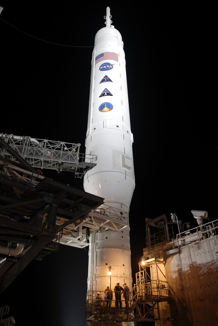 CAPE CANAVERAL, Fla. - Workers on Launch Pad 39B at NASA's Kennedy Space Center in Florida make final preparations for launch of the Constellation Program's 327-foot-tall Ares I-X rocket. The rotating service structure and the arms of the vehicle stabilization system will be moved from around the rocket for liftoff. The transfer of the pad from the Space Shuttle Program to the Constellation Program took place May 31. Modifications made to the pad include the removal of shuttle unique subsystems, such as the orbiter access arm and a section of the gaseous oxygen vent arm, and the installation of three 600-foot lightning towers, access platforms, environmental control systems and a vehicle stabilization system. The data returned from more than 700 sensors throughout the rocket will be used to refine the design of future launch vehicles and bring NASA one step closer to reaching its exploration goals. The Ares I-X flight test is targeted for Oct. 27. For information on the Ares I-X vehicle and flight test, visit http://www.nasa.gov/aresIX. Photo credit: NASA/Kim Shiflett