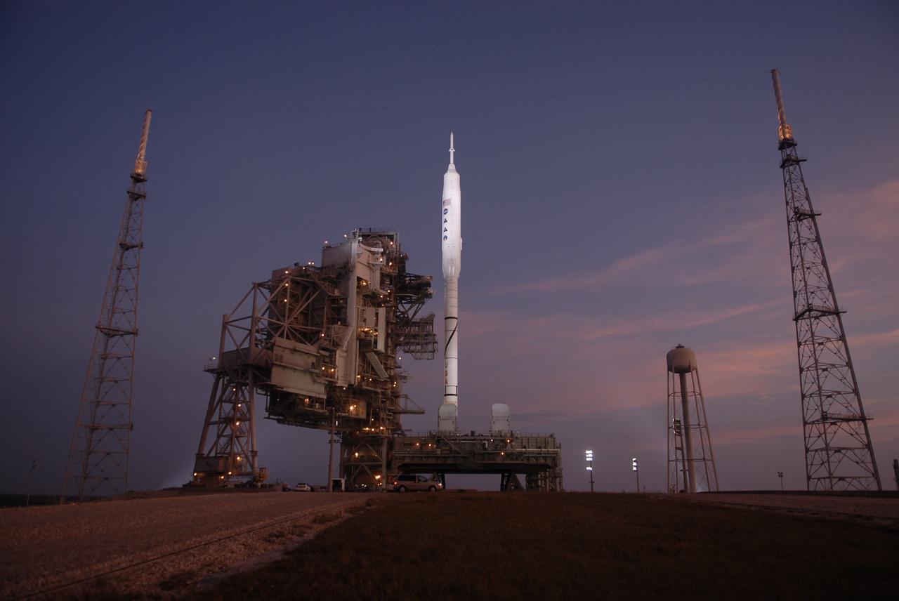CAPE CANAVERAL, Fla. – As the sun rises over Launch Pad 39B at NASA's Kennedy Space Center in Florida, the rotating service structure and the arms of the vehicle stabilization system have been retracted from around the Constellation Program's 327-foot-tall Ares I-X rocket, resting atop its mobile launcher platform, for launch. The transfer of the pad from the Space Shuttle Program to the Constellation Program took place May 31. Modifications made to the pad include the removal of shuttle unique subsystems, such as the orbiter access arm and a section of the gaseous oxygen vent arm, and the installation of three 600-foot lightning towers, access platforms, environmental control systems and a vehicle stabilization system. The data returned from more than 700 sensors throughout the rocket will be used to refine the design of future launch vehicles and bring NASA one step closer to reaching its exploration goals. The Ares I-X flight test is targeted for Oct. 27. For information on the Ares I-X vehicle and flight test, visit http://www.nasa.gov/aresIX. Photo credit: NASA/Kim Shiflett