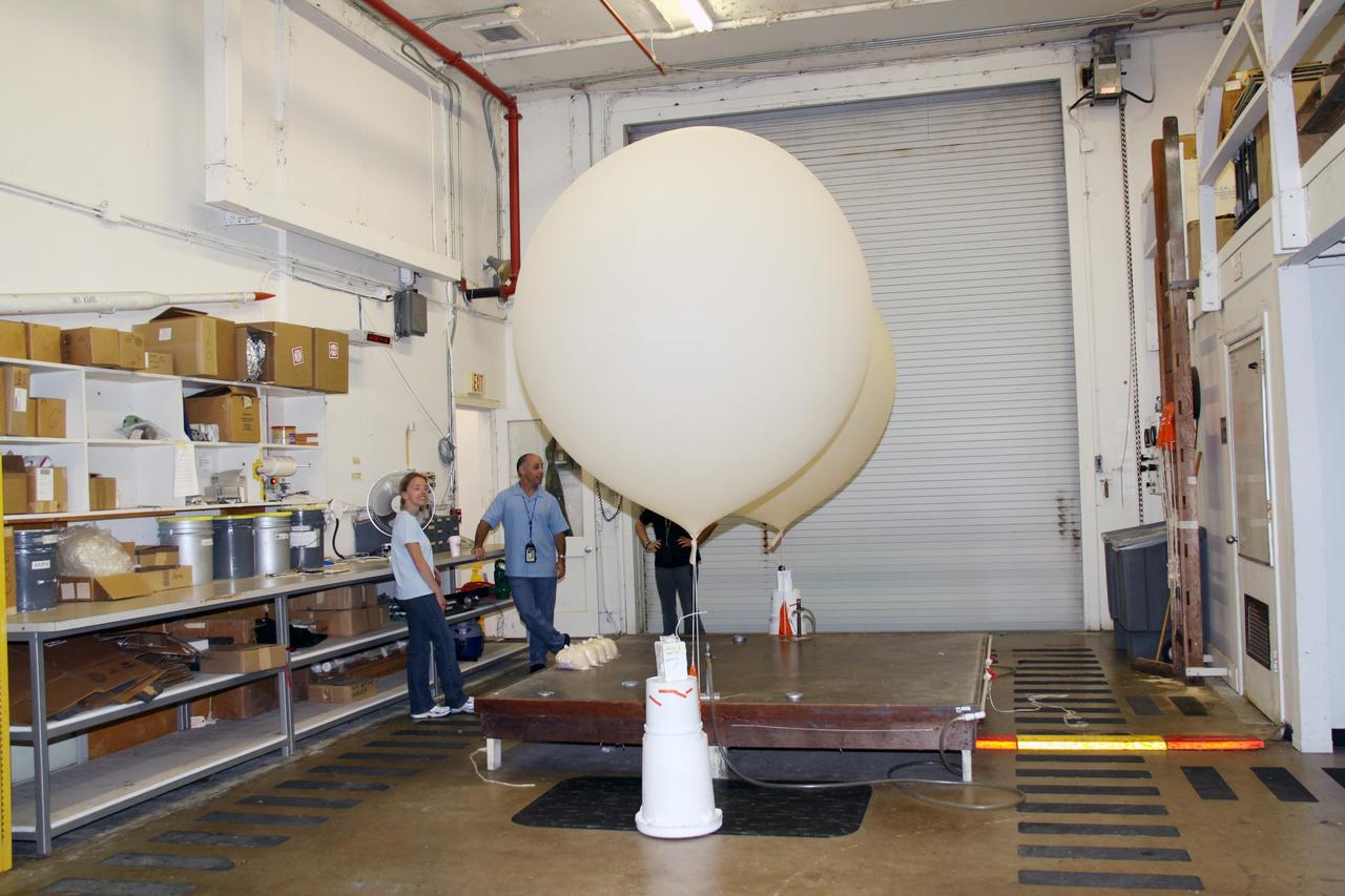 CAPE CANAVERAL, Fla. - In the weather station on Cape Canaveral Air Force Station in Florida, meteorological data specialists prepare two low resolution flight element rawinsonde to support the countdown for the flight test of NASA's Ares I-X rocket.    A GPS-tracked weather balloon, a rawinsonde has a tethered instrument package which radios its altitude to the ground along with atmospheric data such as temperature, dewpoint and humidity, and wind speed and direction.  Rawinsondes can reach altitudes up to 110,000 feet.  For information on the Ares I-X vehicle and flight test, visit http://www.nasa.gov/aresIX.  Photo credit: NASA/Jack Pfaller