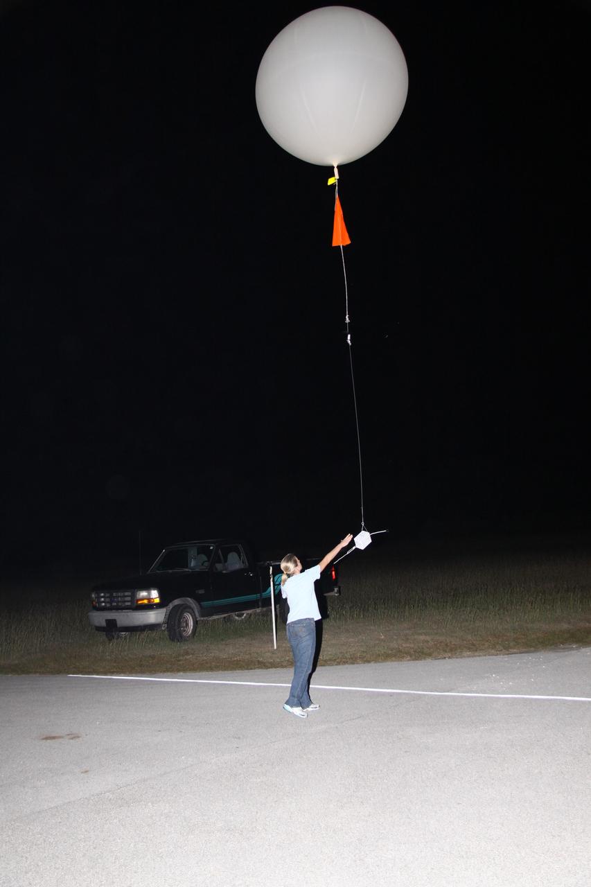 CAPE CANAVERAL, Fla. - At the weather station on Cape Canaveral Air Force Station in Florida, a meteorological data specialist releases a low resolution flight element rawinsonde to support the countdown for the flight test of NASA's Ares I-X rocket.    A GPS-tracked weather balloon, a rawinsonde has a tethered instrument package which radios its altitude to the ground along with atmospheric data such as temperature, dewpoint and humidity, and wind speed and direction.  Rawinsondes can reach altitudes up to 110,000 feet.  For information on the Ares I-X vehicle and flight test, visit http://www.nasa.gov/aresIX.  Photo credit: NASA/Jack Pfaller