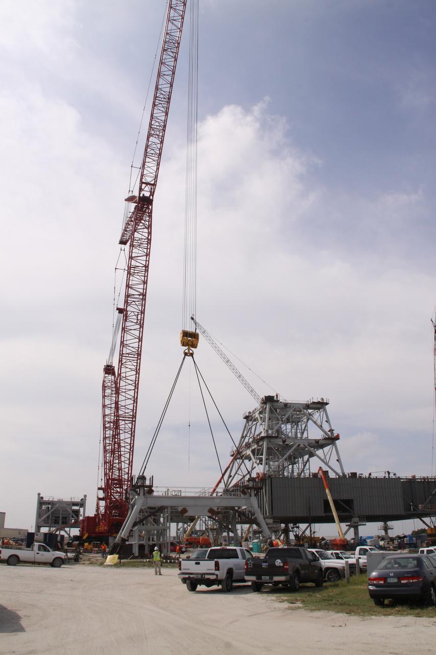 CAPE CANAVERAL, Fla. – At NASA's Kennedy Space Center in Florida, progress continues on the construction of a new mobile launcher, or ML, for the Constellation Program as a crane begins to lift the third section of the launcher's tower from the ground. Installation of the first section was on Sept. 24, and the second, on Oct. 15. The tower will have multiple platforms for personnel access and be approximately 345 feet tall. The launcher is being built at the mobile launcher park site area located north of Kennedy's Vehicle Assembly Building to support the Ares I rocket. The ML will provide a base to launch the Ares I, designed to transport the Orion crew exploration vehicle, its crew and cargo to low Earth orbit. The base is being made lighter than space shuttle mobile launcher platforms so the crawler-transporter can pick up the heavier load of the tower and taller rocket. For information on the Ares I, visit http://www.nasa.gov/ares. Photo credit: NASA/Jack Pfaller