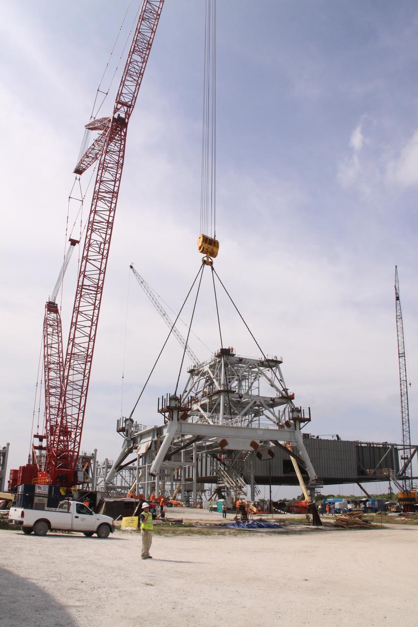 CAPE CANAVERAL, Fla. – At NASA's Kennedy Space Center in Florida, progress continues on the construction of a new mobile launcher, or ML, for the Constellation Program as a crane lifts the third section of the launcher's tower from the ground. Installation of the first section was on Sept. 24, and the second, on Oct. 15. The tower will have multiple platforms for personnel access and be approximately 345 feet tall. The launcher is being built at the mobile launcher park site area located north of Kennedy's Vehicle Assembly Building to support the Ares I rocket. The ML will provide a base to launch the Ares I, designed to transport the Orion crew exploration vehicle, its crew and cargo to low Earth orbit. The base is being made lighter than space shuttle mobile launcher platforms so the crawler-transporter can pick up the heavier load of the tower and taller rocket. For information on the Ares I, visit http://www.nasa.gov/ares. Photo credit: NASA/Jack Pfaller