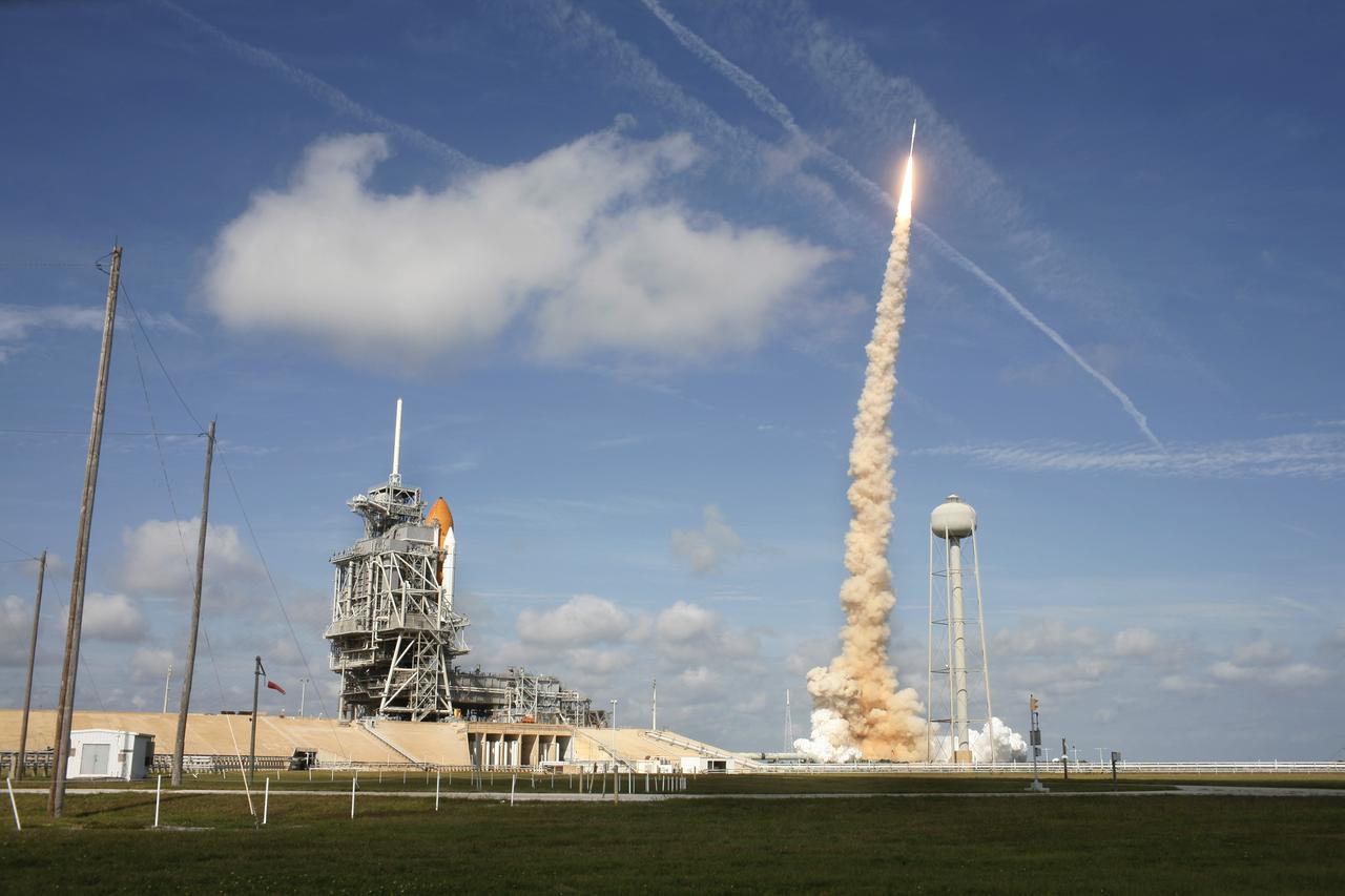 CAPE CANAVERAL, Fla. - With more than 12 times the thrust produced by a Boeing 747 jet aircraft, the Constellation Program's Ares I-X test rocket roars off Launch Pad 39B at NASA's Kennedy Space Center in Florida. The rocket produces 2.96 million pounds of thrust at liftoff and goes supersonic in 39 seconds. At left is space shuttle Atlantis, poised on Launch Pad 39A for liftoff, targeted for Nov. 16. Liftoff of the 6-minute flight test was at 11:30 a.m. EDT Oct. 28. This was the first launch from Kennedy's pads of a vehicle other than the space shuttle since the Apollo Program's Saturn rockets were retired. The parts used to make the Ares I-X booster flew on 30 different shuttle missions ranging from STS-29 in 1989 to STS-106 in 2000. The data returned from more than 700 sensors throughout the rocket will be used to refine the design of future launch vehicles and bring NASA one step closer to reaching its exploration goals. For information on the Ares I-X vehicle and flight test, visit http://www.nasa.gov/aresIX. Photo courtesy of Scott Andrews