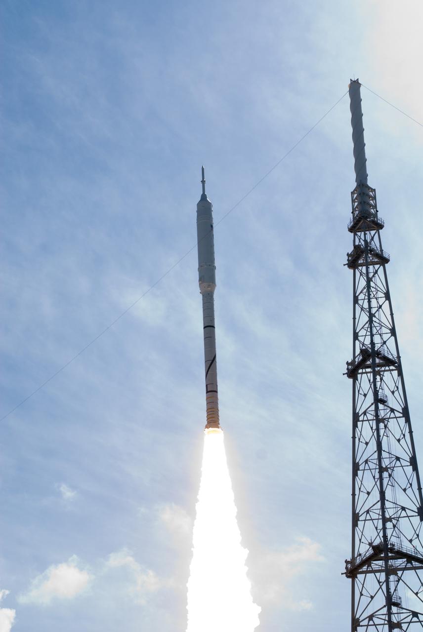 CAPE CANAVERAL, Fla. – NASA's Ares I-X test rocket soars above one of the nearby lightning protection masts at Launch pad 39B as the rocket launches at 11:30 a.m. EDT on Oct. 28. The rocket, part of NASA's Constellation Program, produces 2.96 million pounds of thrust at liftoff and reaches a speed of 100 mph in eight seconds. This was the first launch from Kennedy's pads of a vehicle other than the space shuttle since the Apollo Program's Saturn rockets were retired. The parts used to make the Ares I-X booster flew on 30 different shuttle missions ranging from STS-29 in 1989 to STS-106 in 2000. The data returned from more than 700 sensors throughout the rocket will be used to refine the design of future launch vehicles and bring NASA one step closer to reaching its exploration goals. For information on the Ares I-X vehicle and flight test, visit http://www.nasa.gov/aresIX. Photo credit: NASA/ George Roberts and Tony Gray