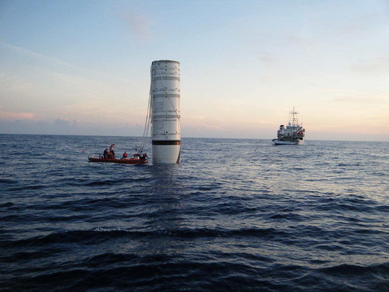 CAPE CANAVERAL, Fla. – In the Atlantic Ocean off the coast of NASA's Kennedy Space Center in Florida, United Space Alliance Recovery Operations divers and personnel approach the vertically floating Ares I-X first stage following the launch of the flight test mission as the solid rocket booster recovery ship Freedom Star stands by to tow it back to the center.    Liftoff of the 6-minute flight test was at 11:30 a.m. EDT Oct. 28. This was the first launch from Kennedy's pads of a vehicle other than the space shuttle since the Apollo Program's Saturn rockets were retired.  The parts used to make the Ares I-X booster flew on 30 different shuttle missions ranging from STS-29 in 1989 to STS-106 in 2000. The data returned from more than 700 sensors throughout the rocket will be used to refine the design of future launch vehicles and bring NASA one step closer to reaching its exploration goals.  For information on the Ares I-X vehicle and flight test, visit http://www.nasa.gov/aresIX.  Photo credit: United Space Alliance