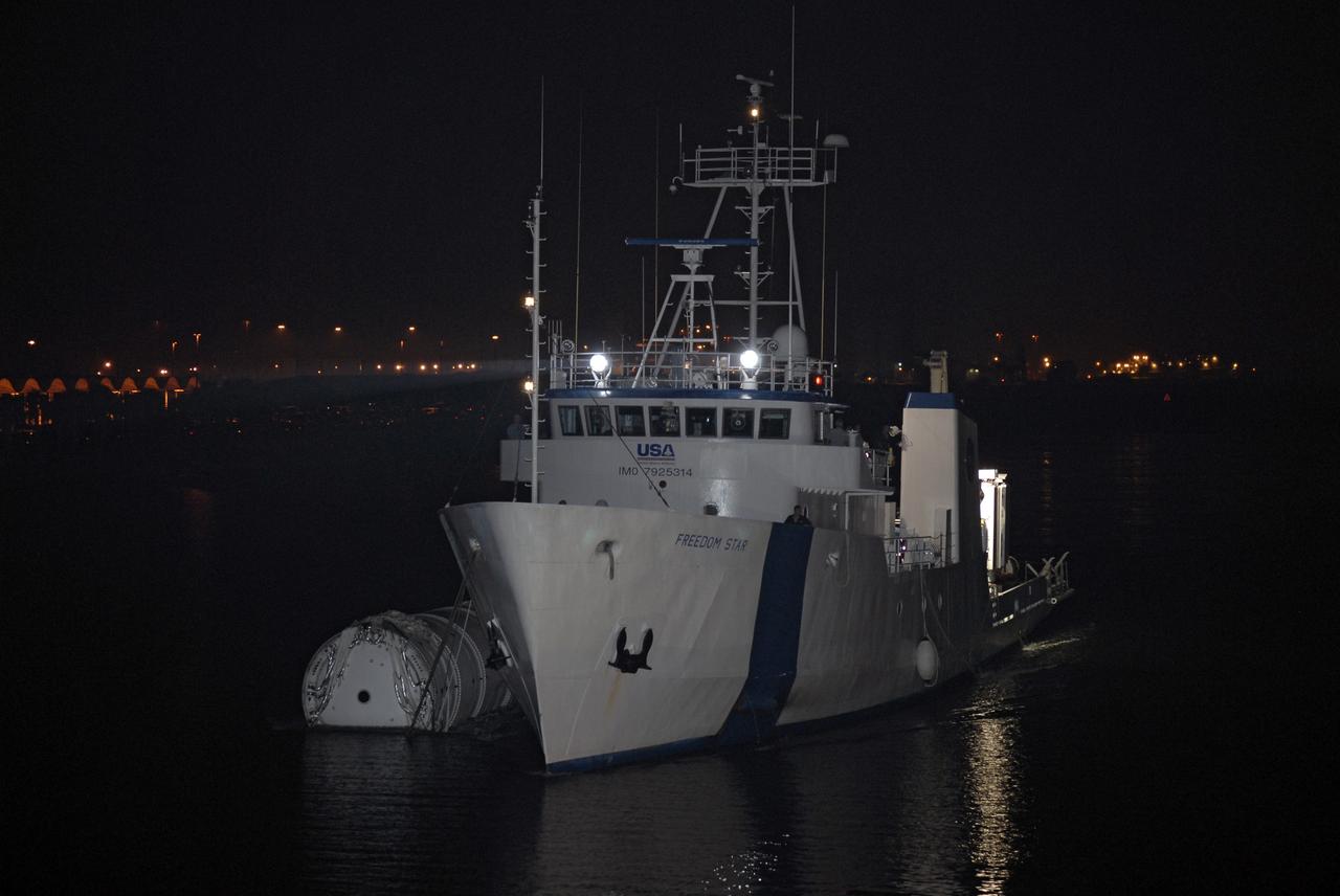 CAPE CANAVERAL, Fla. – The solid rocket booster recovery ship Freedom Star, towing the spent first stage of NASA's Ares I-X rocket, passes through Port Canaveral in Florida. Following the launch of the Ares I-X flight test, the booster splashed down in the Atlantic Ocean and was recovered.    Liftoff of the 6-minute flight test was at 11:30 a.m. EDT Oct. 28. This was the first launch from Kennedy's pads of a vehicle other than the space shuttle since the Apollo Program's Saturn rockets were retired.  The parts used to make the Ares I-X booster flew on 30 different shuttle missions ranging from STS-29 in 1989 to STS-106 in 2000. The data returned from more than 700 sensors throughout the rocket will be used to refine the design of future launch vehicles and bring NASA one step closer to reaching its exploration goals.  For information on the Ares I-X vehicle and flight test, visit http://www.nasa.gov/aresIX.  Photo credit: NASA/Kim Shiflett