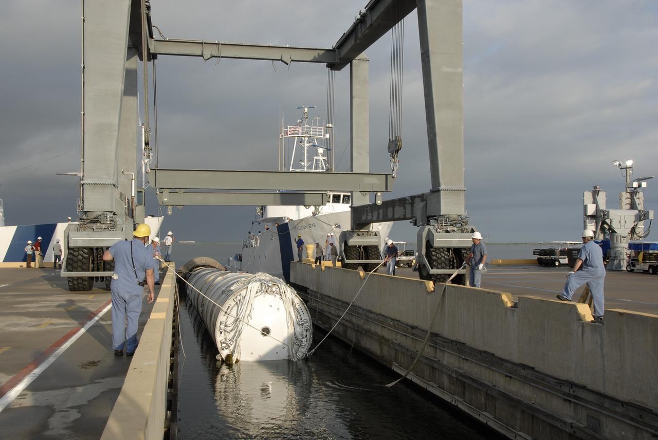 CAPE CANAVERAL, Fla. – The solid rocket booster recovery ship Freedom Star delivers the spent first stage of NASA's Ares I-X rocket to Hangar AF at Cape Canaveral Air Force Station in Florida. Following the launch of the Ares I-X flight test, the booster splashed down in the Atlantic Ocean and was recovered.    Liftoff of the 6-minute flight test was at 11:30 a.m. EDT Oct. 28. This was the first launch from Kennedy's pads of a vehicle other than the space shuttle since the Apollo Program's Saturn rockets were retired.  The parts used to make the Ares I-X booster flew on 30 different shuttle missions ranging from STS-29 in 1989 to STS-106 in 2000. The data returned from more than 700 sensors throughout the rocket will be used to refine the design of future launch vehicles and bring NASA one step closer to reaching its exploration goals.  For information on the Ares I-X vehicle and flight test, visit http://www.nasa.gov/aresIX.  Photo credit: NASA/Kim Shiflett