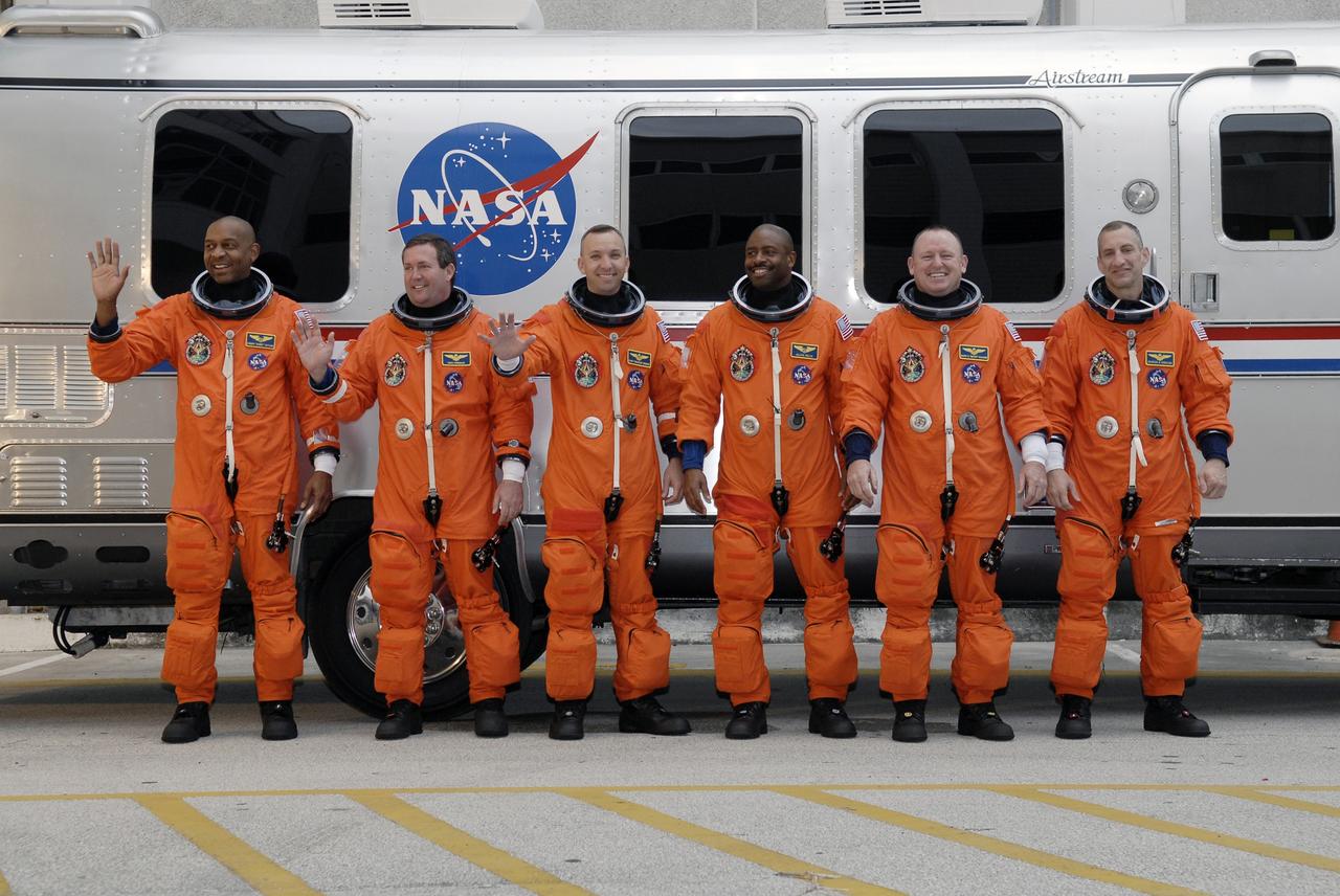 CAPE CANAVERAL, Fla. - At the Operations and Checkout Building at NASA's Kennedy Space Center in Florida, the members of the STS-129 crew line up beside the Astrovan for a portrait in their launch-and-entry suits. The six astronauts for space shuttle Atlantis’ STS-129 mission are en route to their launch dress rehearsal, the Terminal Countdown Demonstration Test, at Launch Pad 39A.  From left are Mission Specialists Robert L. Satcher Jr., Mike Foreman, Randy Bresnik and Leland Melvin; Pilot Barry E. Wilmore; and Commander Charles O. Hobaugh.    Additional training associated with the test was done last month, but the simulated countdown was postponed because of a scheduling conflict with the launch of NASA’s Ares I-X test rocket.  Launch of Atlantis on its STS-129 mission to the International Space Station is set for Nov. 16.  On STS-129, the crew will deliver to the station two spare gyroscopes, two nitrogen tank assemblies, two pump modules, an ammonia tank assembly and a spare latching end effector for the station's robotic arm.  For information on the STS-129 crew and mission objectives, visit http://www.nasa.gov/mission_pages/shuttle/shuttlemissions/sts129/index.html. Photo credit: NASA/Kim Shiflett