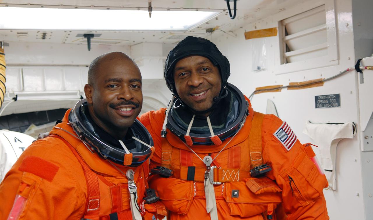 CAPE CANAVERAL, Fla. - On Launch Pad 39A at NASA's Kennedy Space Center in Florida, STS-129 Mission Specialists Leland Melvin, left, and Robert L. Satcher Jr. are preparing to enter space shuttle Atlantis with the help of the closeout crew in the White Room. The six astronauts for space shuttle Atlantis’ STS-129 mission are participating in their launch dress rehearsal, the Terminal Countdown Demonstration Test. Additional training associated with the test was done last month, but the simulated countdown was postponed because of a scheduling conflict with the launch of NASA’s Ares I-X test rocket. Launch of Atlantis on its STS-129 mission to the International Space Station is set for Nov. 16. On STS-129, the crew will deliver to the station two spare gyroscopes, two nitrogen tank assemblies, two pump modules, an ammonia tank assembly and a spare latching end effector for the station's robotic arm. For information on the STS-129 crew and mission objectives, visit http://www.nasa.gov/mission_pages/shuttle/shuttlemissions/sts129/index.html. Photo credit: NASA/Jim Grossmann