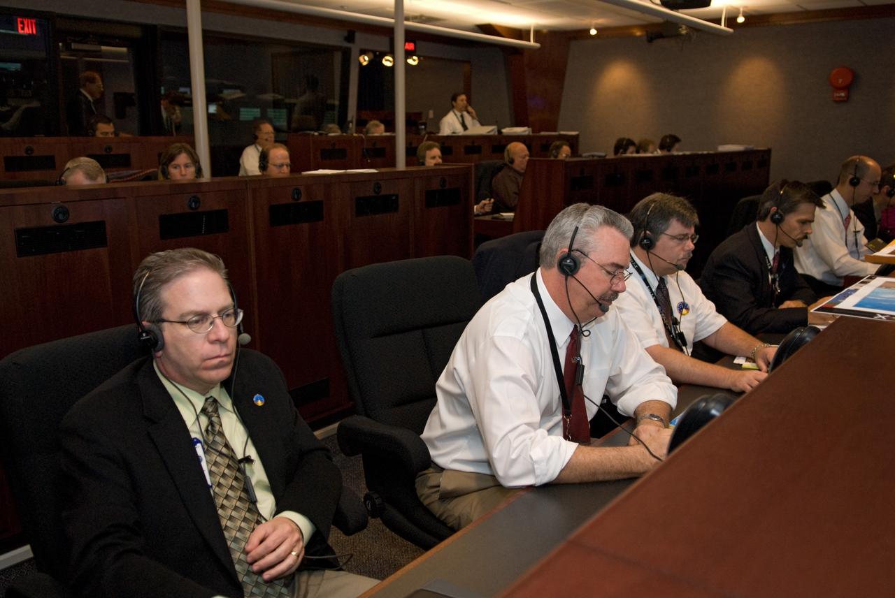 CAPE CANAVERAL, Fla. - The launch support team for the Ares I-X flight test monitors the countdown from consoles from the Mission Director's Center in Hangar AE on Cape Canaveral Air Force Station in Florida.    This will be the first launch from Kennedy's pads of a vehicle other than the space shuttle since the Apollo Program's Saturn rockets were retired.  The parts used to make the Ares I-X booster flew on 30 different shuttle missions ranging from STS-29 in 1989 to STS-106 in 2000. The data returned from more than 700 sensors throughout the rocket will be used to refine the design of future launch vehicles and bring NASA one step closer to reaching its exploration goals.  For information on the Ares I-X vehicle and flight test, visit http://www.nasa.gov/aresIX.  Photo credit: NASA/Kim Shiflett