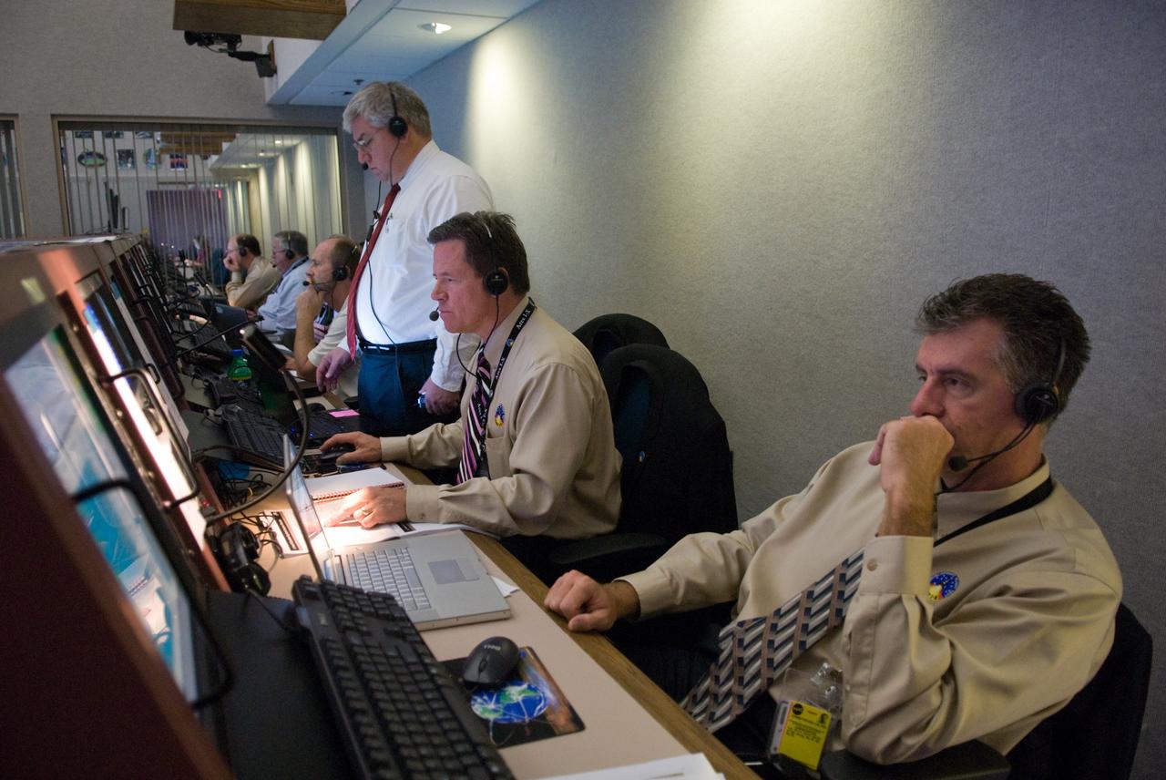 CAPE CANAVERAL, Fla. - The launch support team for the Ares I-X flight test monitors the countdown from consoles from the Launch Vehicle Data Center in Hangar AE on Cape Canaveral Air Force Station in Florida.    This will be the first launch from Kennedy's pads of a vehicle other than the space shuttle since the Apollo Program's Saturn rockets were retired.  The parts used to make the Ares I-X booster flew on 30 different shuttle missions ranging from STS-29 in 1989 to STS-106 in 2000. The data returned from more than 700 sensors throughout the rocket will be used to refine the design of future launch vehicles and bring NASA one step closer to reaching its exploration goals.  For information on the Ares I-X vehicle and flight test, visit http://www.nasa.gov/aresIX.  Photo credit: NASA/Kim Shiflett