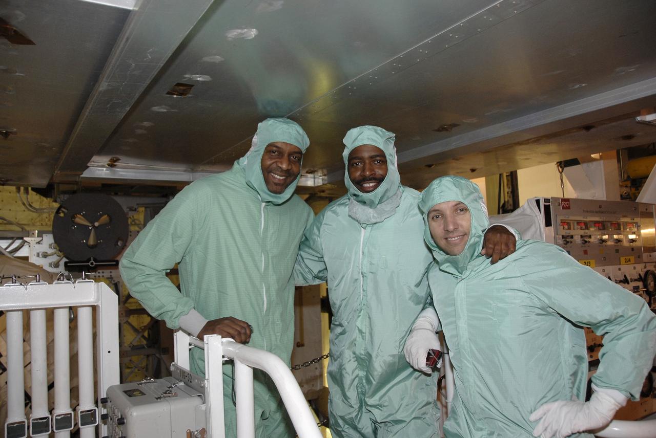 CAPE CANAVERAL, Fla. - In the Payload Changeout Room on Launch Pad 39A at NASA's Kennedy Space Center in Florida, members of the STS-129 crew, dressed in clean-room attire known as "bunny suits," take time out from their payload familiarization training for a photo. From left are Mission Specialists Robert L. Satcher Jr., Leland Melvin, and Randy Bresnik. The training affords the crew an opportunity to observe the placement of the Express Logistics Carriers 1 and 2 in space shuttle Atlantis' payload bay before launch. The six astronauts for space shuttle Atlantis’ STS-129 mission came to Kennedy to participate in their launch dress rehearsal, the Terminal Countdown Demonstration Test. Additional training associated with the test was done last month, but the simulated countdown was postponed because of a scheduling conflict with the launch of NASA’s Ares I-X test rocket. Launch of Atlantis on its STS-129 mission to the International Space Station is set for Nov. 16. On STS-129, the crew will deliver to the station two spare gyroscopes, two nitrogen tank assemblies, two pump modules, an ammonia tank assembly and a spare latching end effector for the station's robotic arm. For information on the STS-129 crew and mission objectives, visit http://www.nasa.gov/mission_pages/shuttle/shuttlemissions/sts129/index.html. Photo credit: NASA/Kim Shiflett