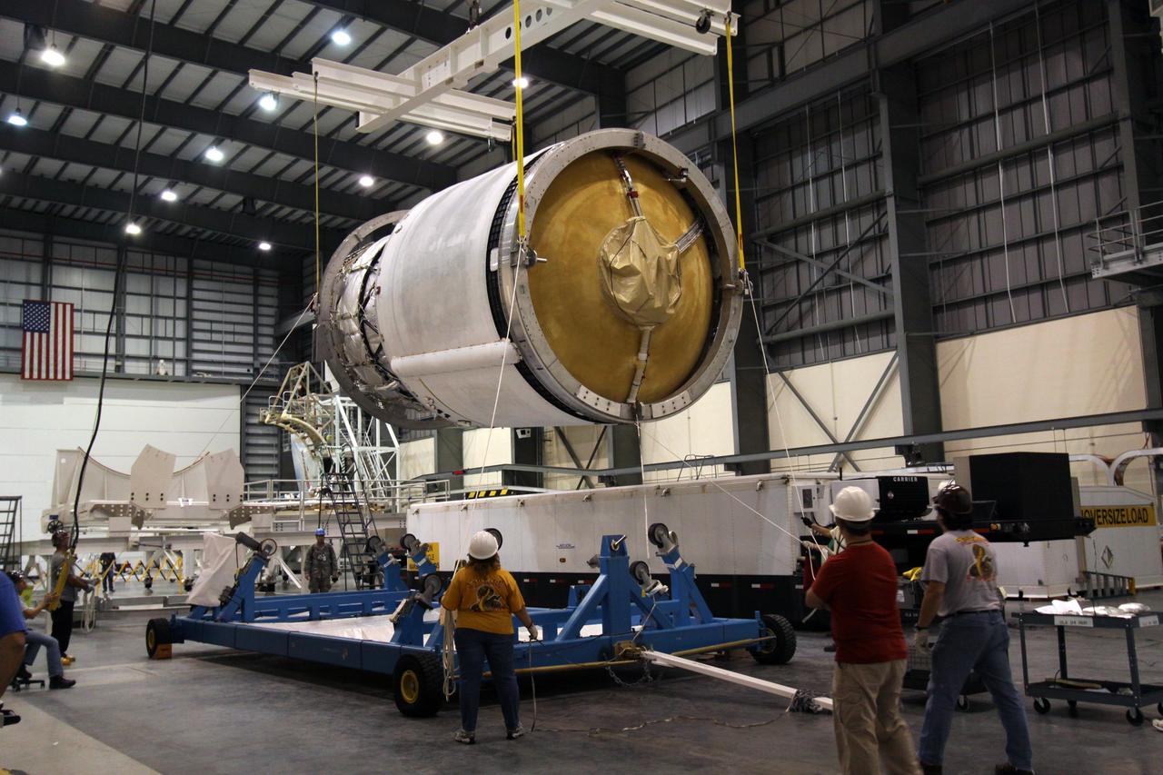 CAPE CANAVERAL, Fla. – Workers move the second stage of a Delta IV from its transporter toward a mobile work stand in the Horizontal Integration Facility at Launch Complex 37 on Cape Canaveral Air Force Station in Florida. This United Launch Alliance Delta IV rocket is the vehicle slated to launch GOES-P, the latest Geostationary Operational Environmental Satellite developed by NASA for the National Oceanic and Atmospheric Administration, or NOAA. Processing of the Delta IV is on track for launch, targeted for March 4, 2010. For information on GOES-P, visit http://goespoes.gsfc.nasa.gov/goes/spacecraft/n_p_spacecraft.html. Photo credit: NASA/Jack Pfaller