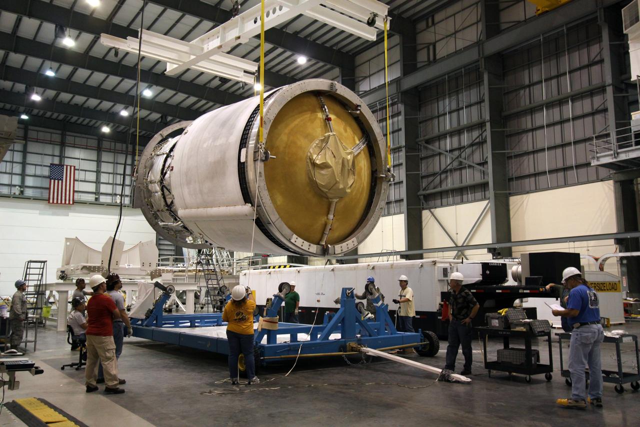 CAPE CANAVERAL, Fla. – Workers lower the second stage of a Delta IV onto a mobile work stand in the Horizontal Integration Facility at Launch Complex 37 on Cape Canaveral Air Force Station in Florida. This United Launch Alliance Delta IV rocket is the vehicle slated to launch GOES-P, the latest Geostationary Operational Environmental Satellite developed by NASA for the National Oceanic and Atmospheric Administration, or NOAA. Processing of the Delta IV is on track for launch, targeted for March 4, 2010. For information on GOES-P, visit http://goespoes.gsfc.nasa.gov/goes/spacecraft/n_p_spacecraft.html. Photo credit: NASA/Jack Pfaller